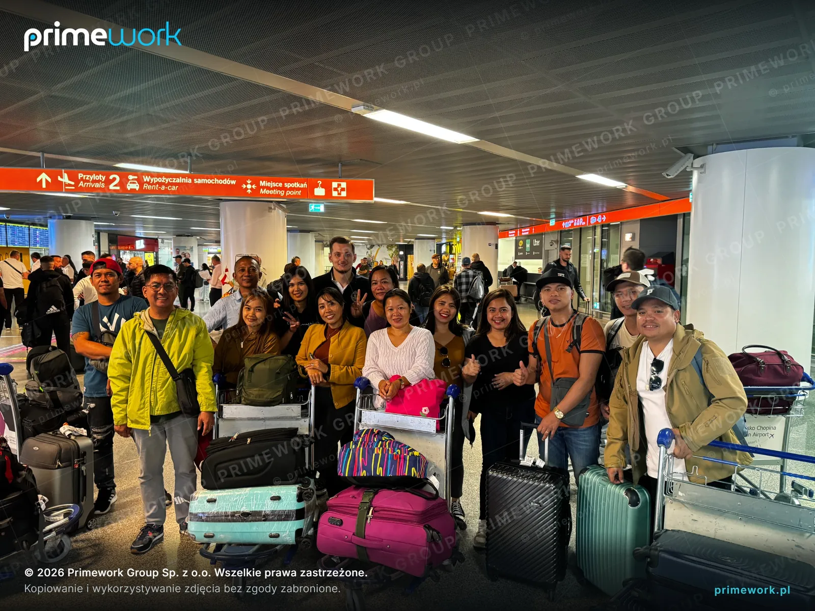 Workers from Asia with luggage in the arrivals hall of Zagreb Airport