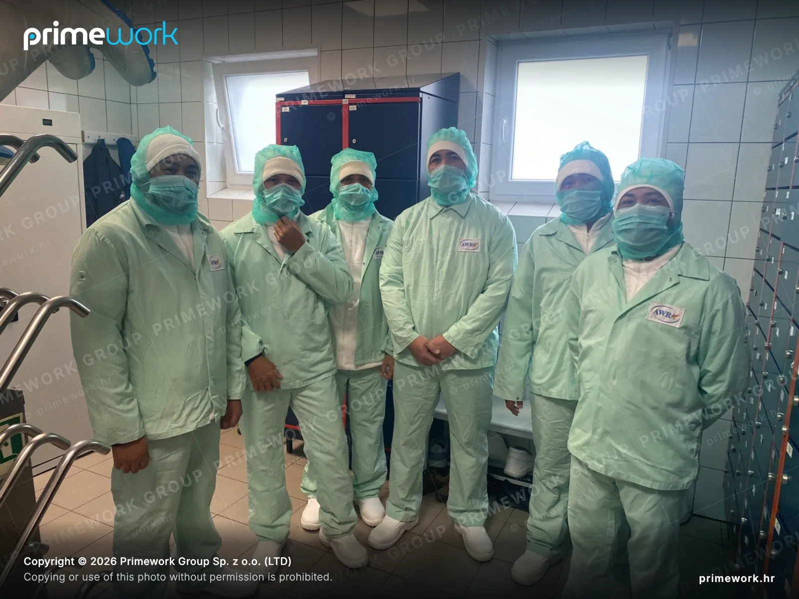 Workers in full protective equipment in a clean production area